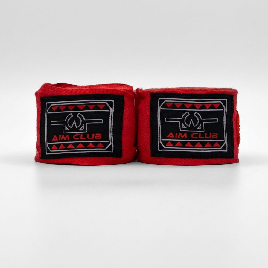 Red boxing hand wraps with 'Aim Club' logo on a white background