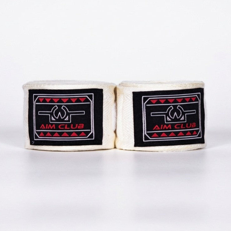 Pair of white boxing hand wraps with black labels on a white background